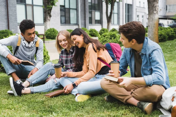 depositphotos 275009648 stock photo smiling teenagers sitting grass talking