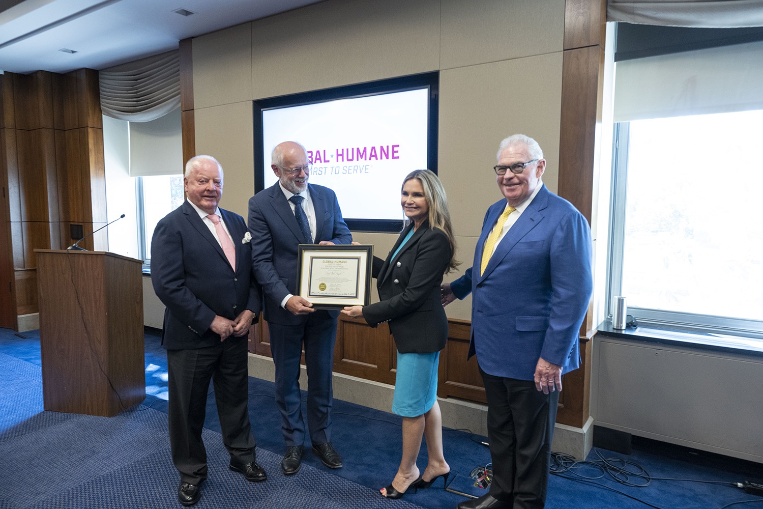Photo credit: American Humane Society | Professor Theo Pagel holds the Kiessling Prize Award with Robin Ganzert, American Humane president and CEO