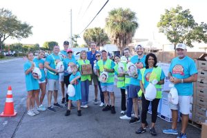4 Boca helping Hands volunteers hold boxes with "all the fixin's" for a Thanksgiving meal 4 Boca helping Hands volunteers hold boxes with "all the fixin's" for a Thanksgiving meal