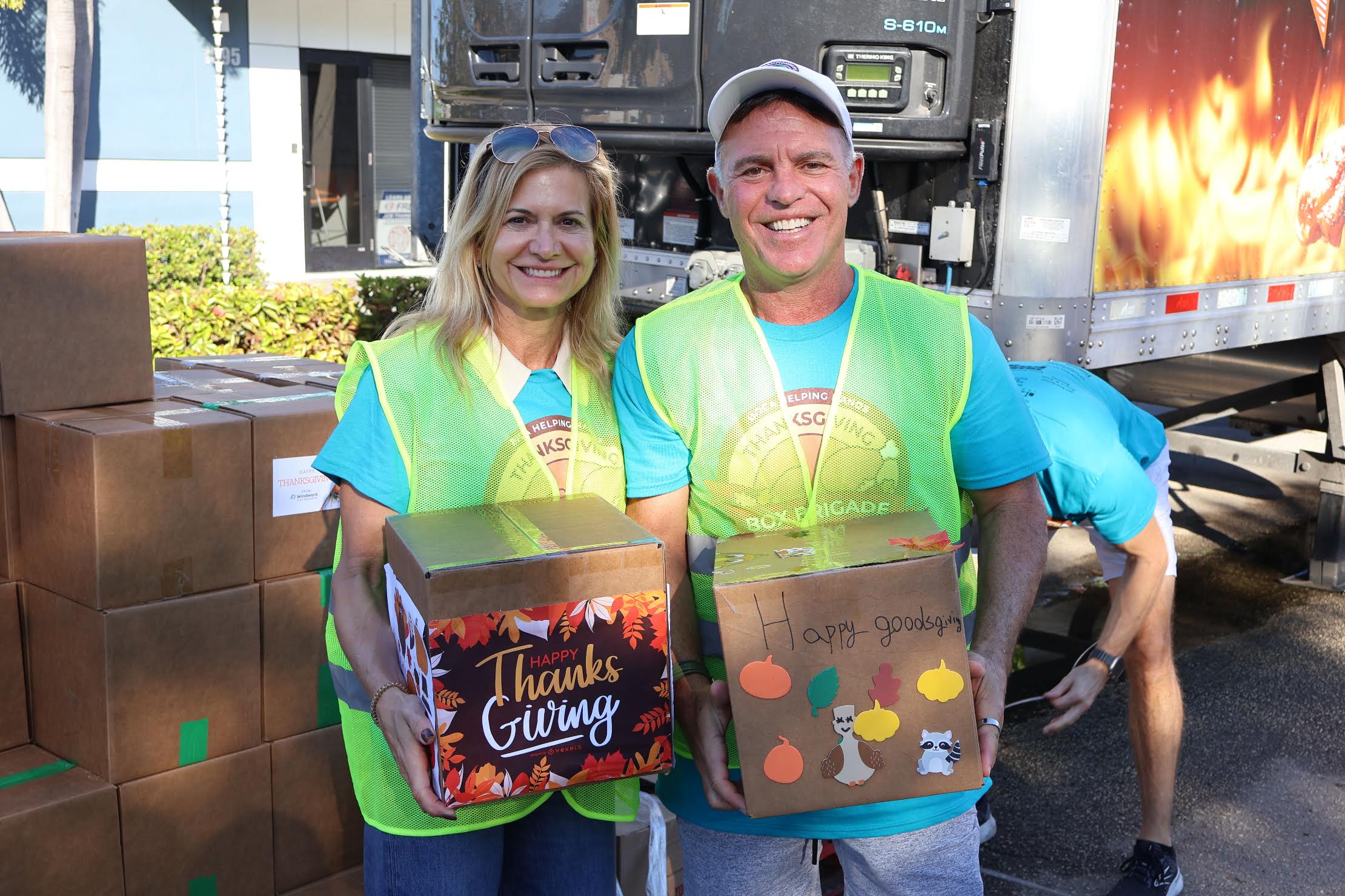 Boca Helping Hands volunteers hold turkeys to be given out in 2025