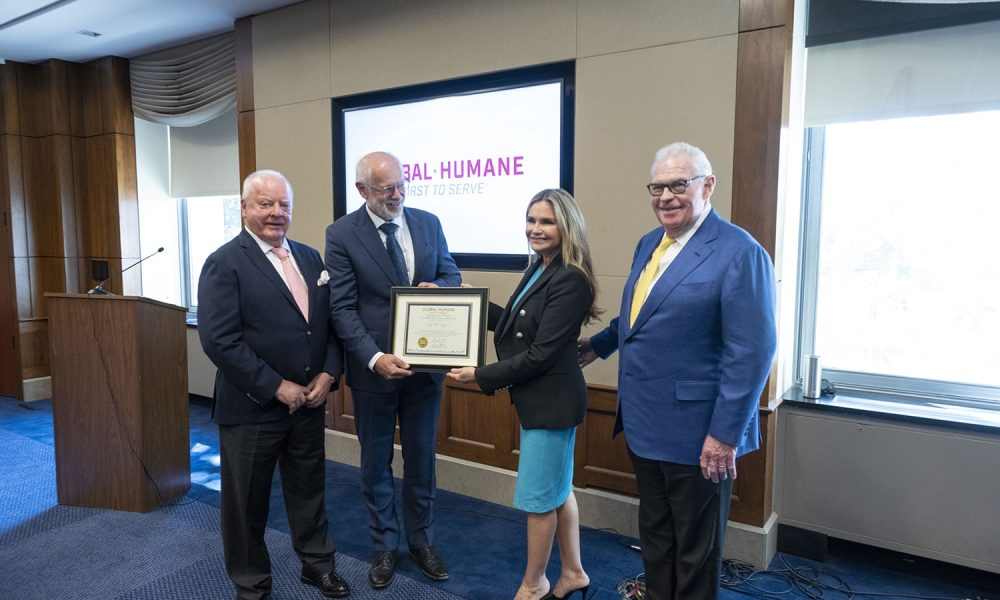 Photo credit: American Humane Society | Professor Theo Pagel holds the Kiessling Prize Award with Robin Ganzert, American Humane president and CEO